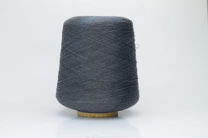Close-up of a finely spun, lustrous dark gray silk yarn, exhibiting a smooth surface and a subtle sheen. The tightly twisted plies are visible, creating a refined, consistent thread structure.