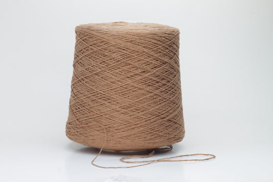 Close-up shot of luxurious Silk Bourette 100% Yarn in Mousse color. The yarn features a delicate, fine ply twist with an exceptionally smooth texture and subtle sheen, showcasing its fluffy softness.