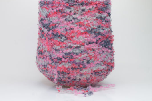Close-up shot of multicolored SuperKidMohair yarn, showcasing its fluffy texture, slight sheen, and tight ply twist – a rich blend ready for knitting or weaving.
