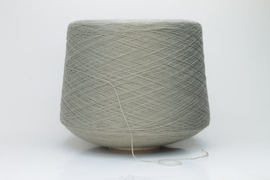 Close-up shot of the grey merino yarn, showcasing its fine 2/30 ply twist and subtle sheen, with a fluffy texture revealed through careful lighting.