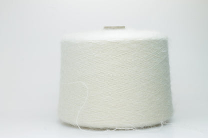 Close-up of fine white Kid Mohair and Silk yarn, exhibiting a soft, ethereal halo and subtle luminous sheen, gently twisted.