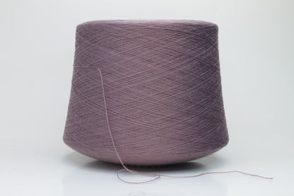 Close-up shot of Zegna Baruffa Merino 100% Cashwool yarn in color 438 Ninfea, showcasing the fine ply twist and rich, deep hue of the fibers.