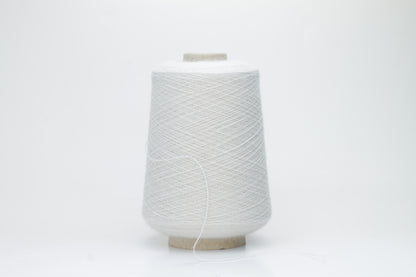Close-up of lustrous beige 2-ply alpaca merino yarn, subtly twisted with a fine, even structure and soft, low halo.