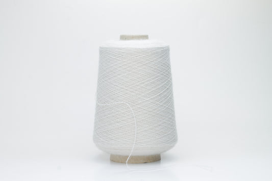 Close-up of lustrous beige 2-ply alpaca merino yarn, subtly twisted with a fine, even structure and soft, low halo.