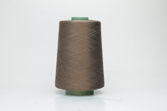 Finely spun, single-ply silk yarn in a deep, rich cacao brown, exhibiting a smooth, tight twist and brilliant, natural sheen.