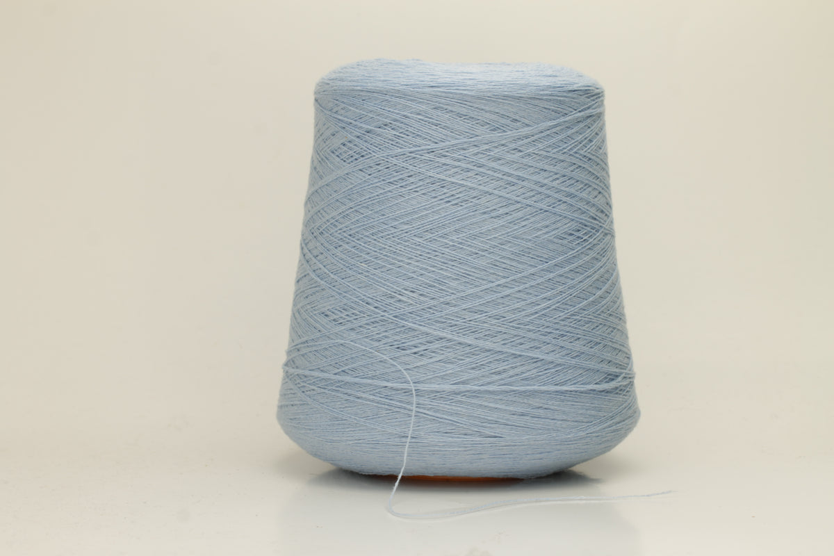 Close-up of a luxurious, soft Atlantic blue 2-ply cashmere yarn, subtly twisted with a delicate sheen and rich, deep color saturation.
