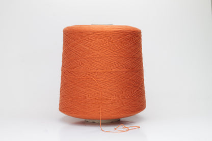 Close-up of luxurious Cognac Merino wool yarn, two-ply twist with a soft, subtle sheen, and fine, consistent thread structure.