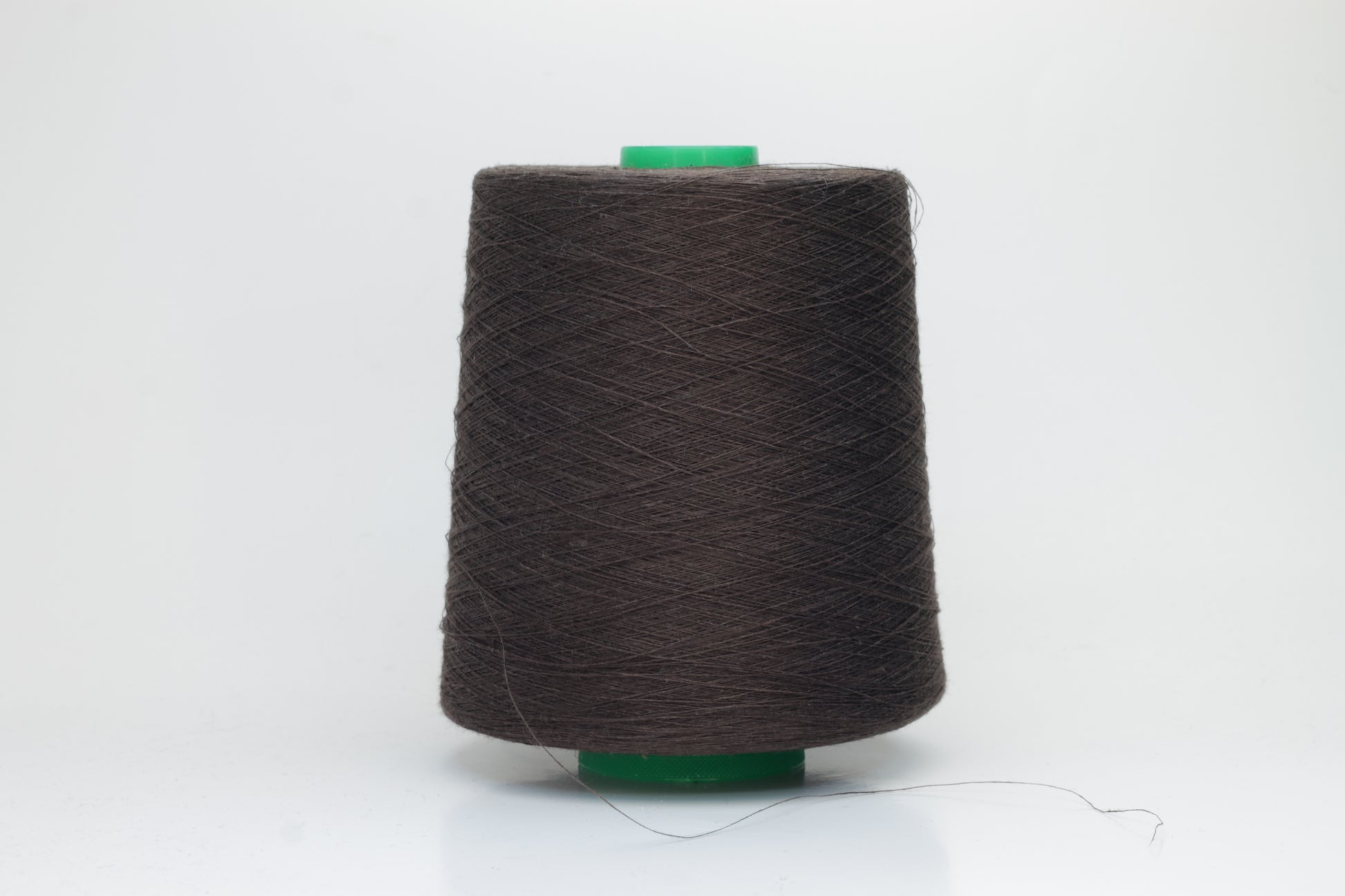Fine, single-ply linen yarn in a rich Brown. Reveals a crisp texture and subtle natural sheen, typical of pure linen fiber.