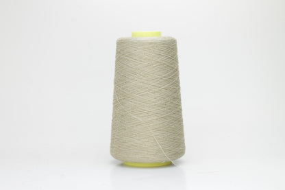 Fine, single-ply linen yarn in a rich Pale Oatmeal. Reveals a crisp texture and subtle natural sheen, typical of pure linen fiber.