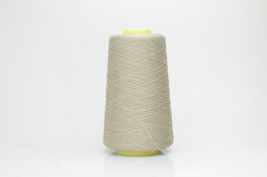 Fine, single-ply linen yarn in a rich Pale Oatmeal. Reveals a crisp texture and subtle natural sheen, typical of pure linen fiber.