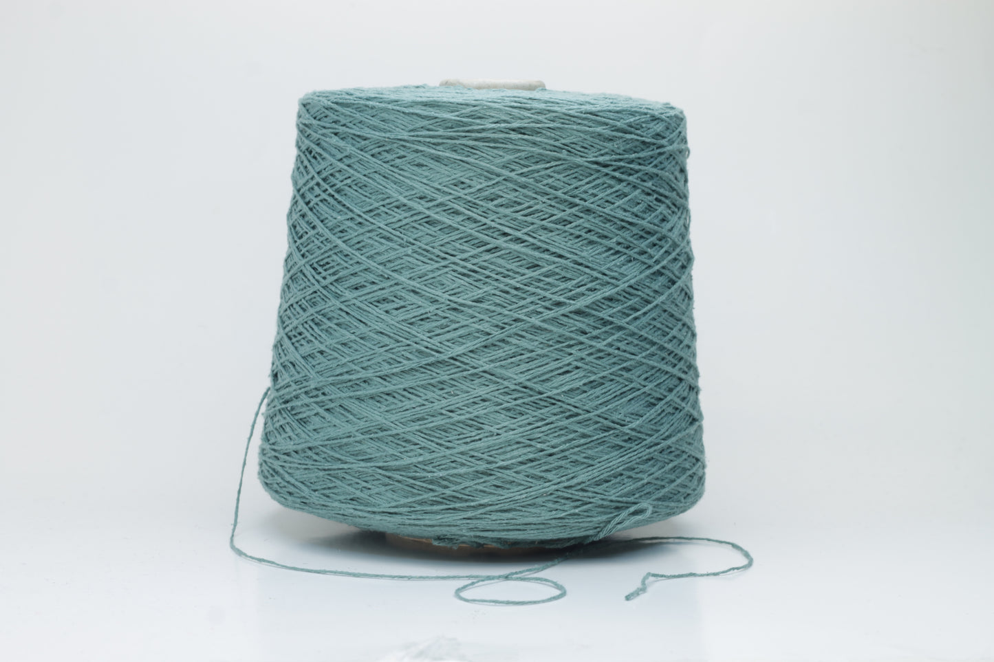 Close-up shot of shimmering silk bourette yarn in a rich verdone color. The multi-plied strands show subtle twist and depth, with a delicate sheen and fluffy texture.