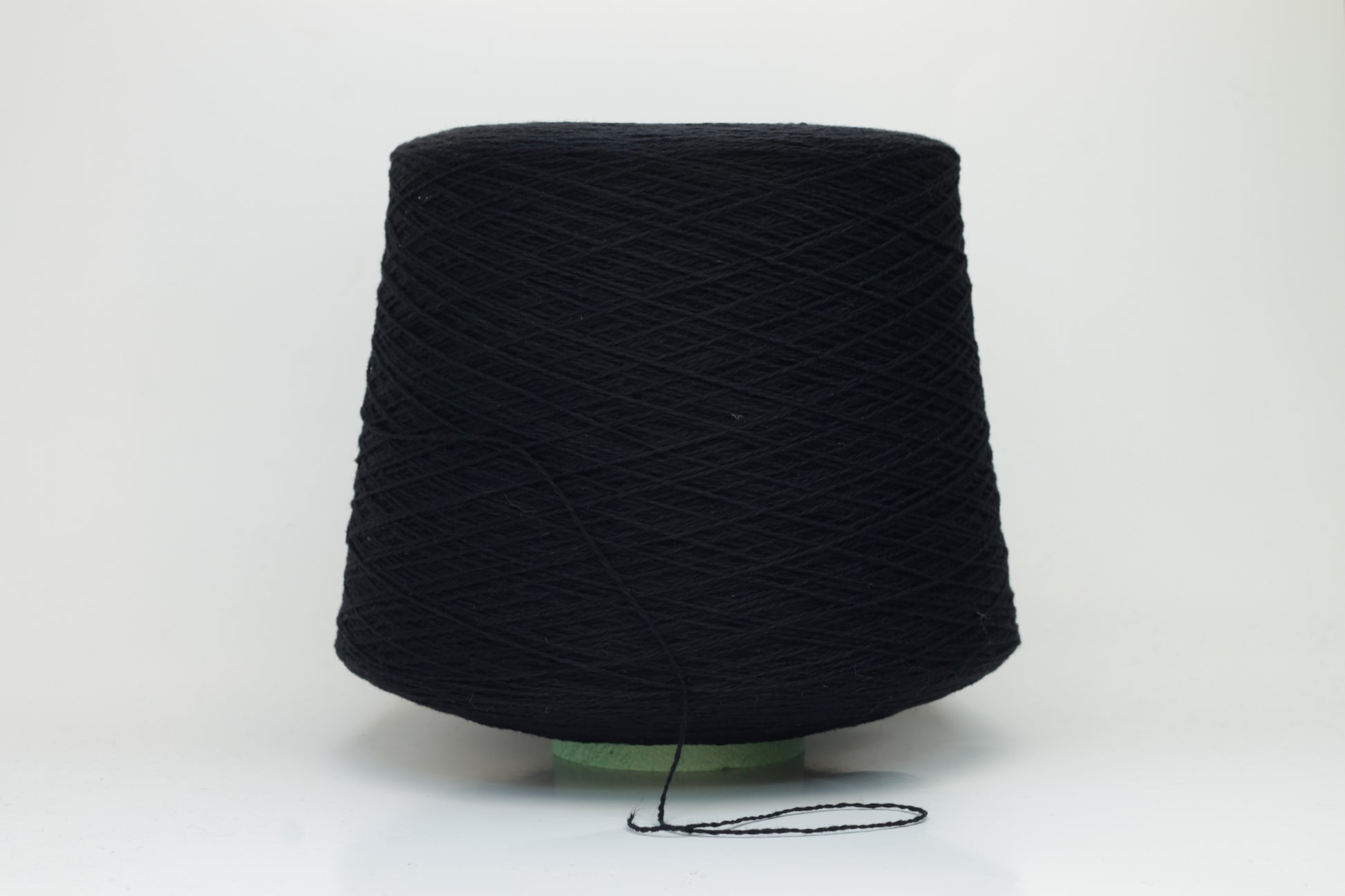 Luxurious black cashmere yarn, two-ply twist with a subtle sheen, displaying deep, consistent color and a fine, soft texture ready for crafting.