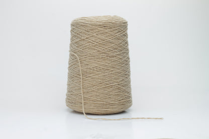 A luxuriously soft skein of pale, warm camel-colored cashmere yarn, gently twisted with a subtle halo, showcasing its delicate and fine fibers.