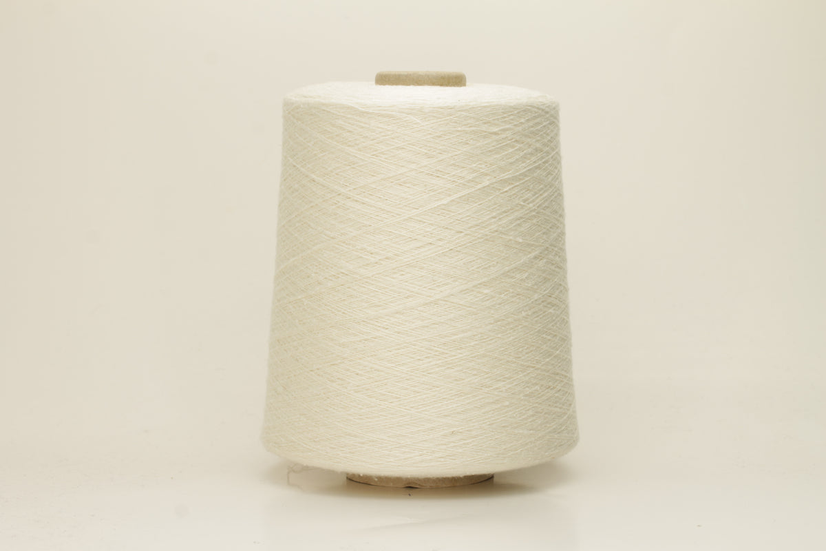 A tightly twisted single strand of luxurious deep royal blue silk yarn, reflecting light with a soft, natural sheen.