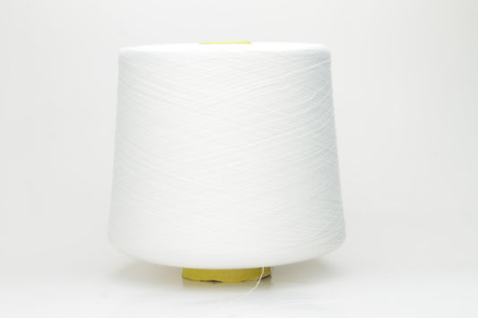 Close-up of a tightly wound, pure white skein of Loro Piana combed cotton yarn. It has a smooth, uniform texture and a subtle, elegant sheen.