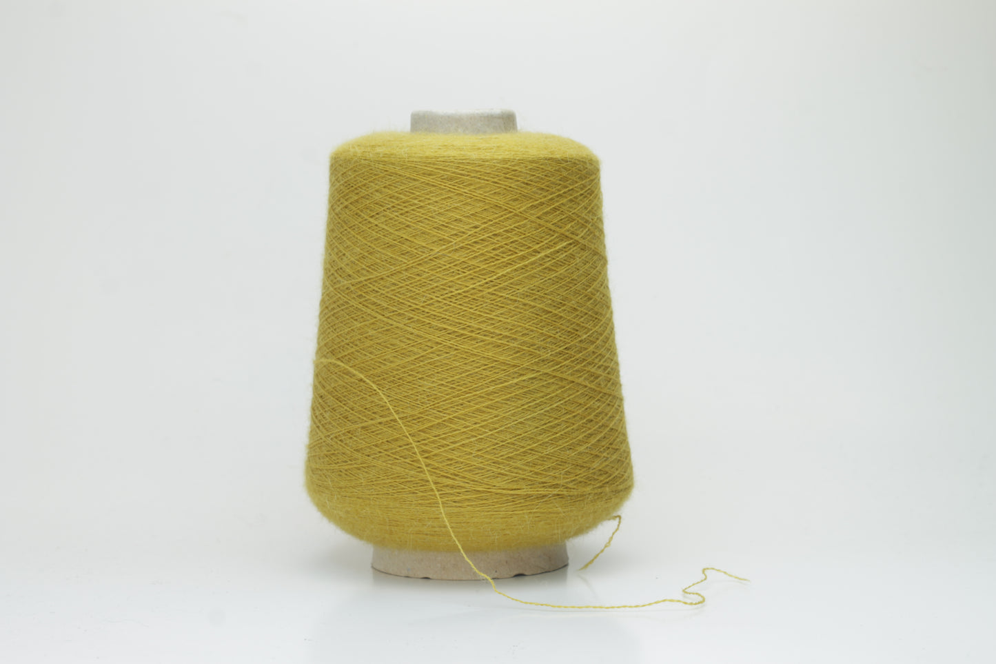Mustard 2-ply Alpaca Merino yarn, softly twisted with a gentle halo and subtle sheen, showcasing its deep, luxurious color saturation.