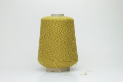 Mustard 2-ply Alpaca Merino yarn, softly twisted with a gentle halo and subtle sheen, showcasing its deep, luxurious color saturation.