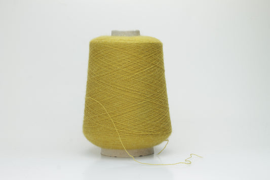 Mustard 2-ply Alpaca Merino yarn, softly twisted with a gentle halo and subtle sheen, showcasing its deep, luxurious color saturation.