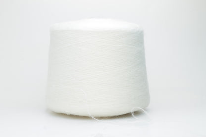 Close-up view of SuperKidMohair yarn in Aurora White color, showcasing its fluffy texture and subtle sheen. The yarn exhibits a smooth ply twist with a rich color depth.