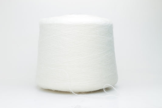 Close-up view of SuperKidMohair yarn in Aurora White color, showcasing its fluffy texture and subtle sheen. The yarn exhibits a smooth ply twist with a rich color depth.