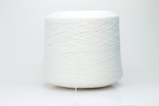 Close-up of pristine white, finely plied 100% cashmere yarn, showcasing its soft halo and subtle sheen on a neutral background.