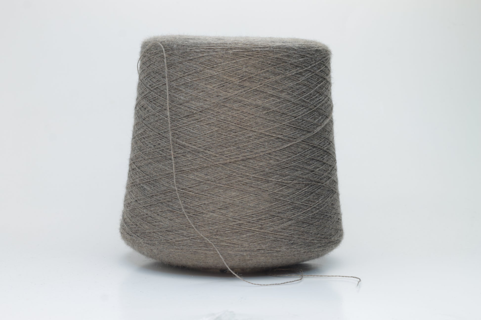 Close-up shot of Zegna Baruffa Merino 100% Cashwool Yarn in Taupe, showcasing a dense ply twist and fine thread structure with subtle sheen and a fluffy texture.