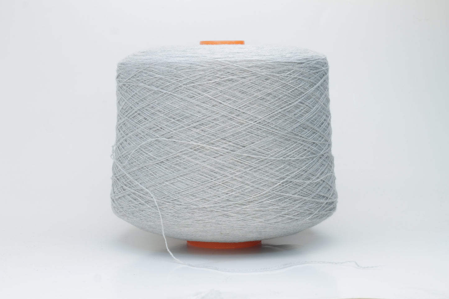 Close-up of a skein of luxurious, soft gray 100% cashmere yarn, featuring a gentle halo and a subtle, refined sheen. The two-ply structure is visible, showing even twist and consistent depth of the elegant cool gray color.