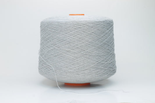 Close-up of a skein of luxurious, soft gray 100% cashmere yarn, featuring a gentle halo and a subtle, refined sheen. The two-ply structure is visible, showing even twist and consistent depth of the elegant cool gray color.