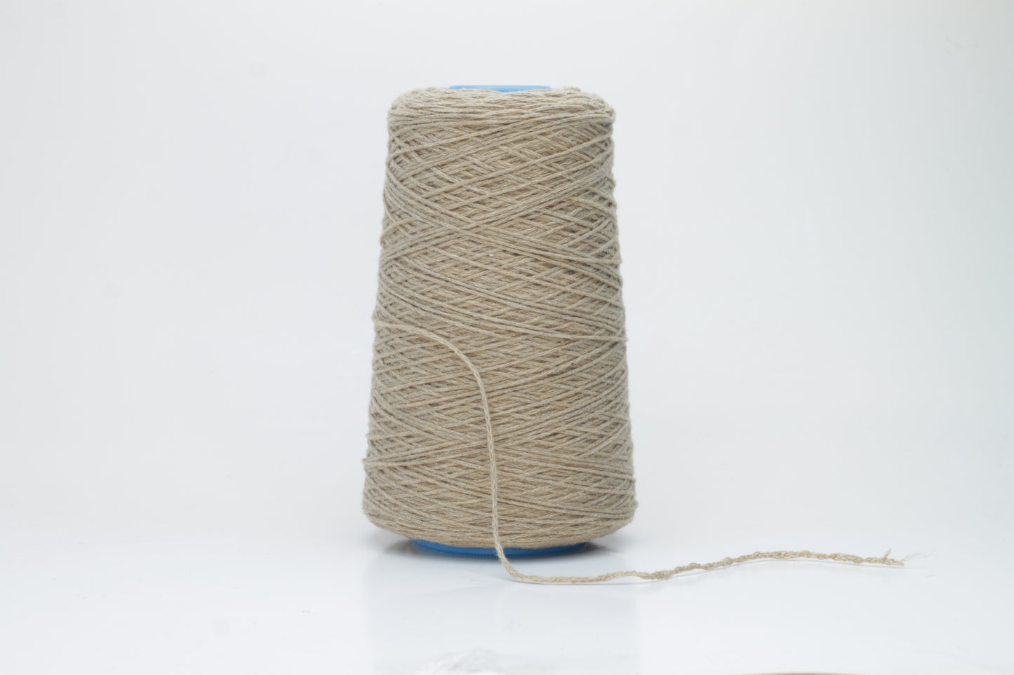 A skein of finely spun single-ply cashmere yarn in a delicate, muted grey-pink 'Polvere' shade, showcasing its inherent soft fluffiness and subtle, natural sheen.