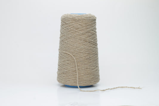 A skein of finely spun single-ply cashmere yarn in a delicate, muted grey-pink 'Polvere' shade, showcasing its inherent soft fluffiness and subtle, natural sheen.