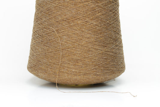 Close-up of a perfectly twisted two-ply cashmere yarn in a rich, warm brown shade, exhibiting a subtle natural sheen and delicate fluffiness.