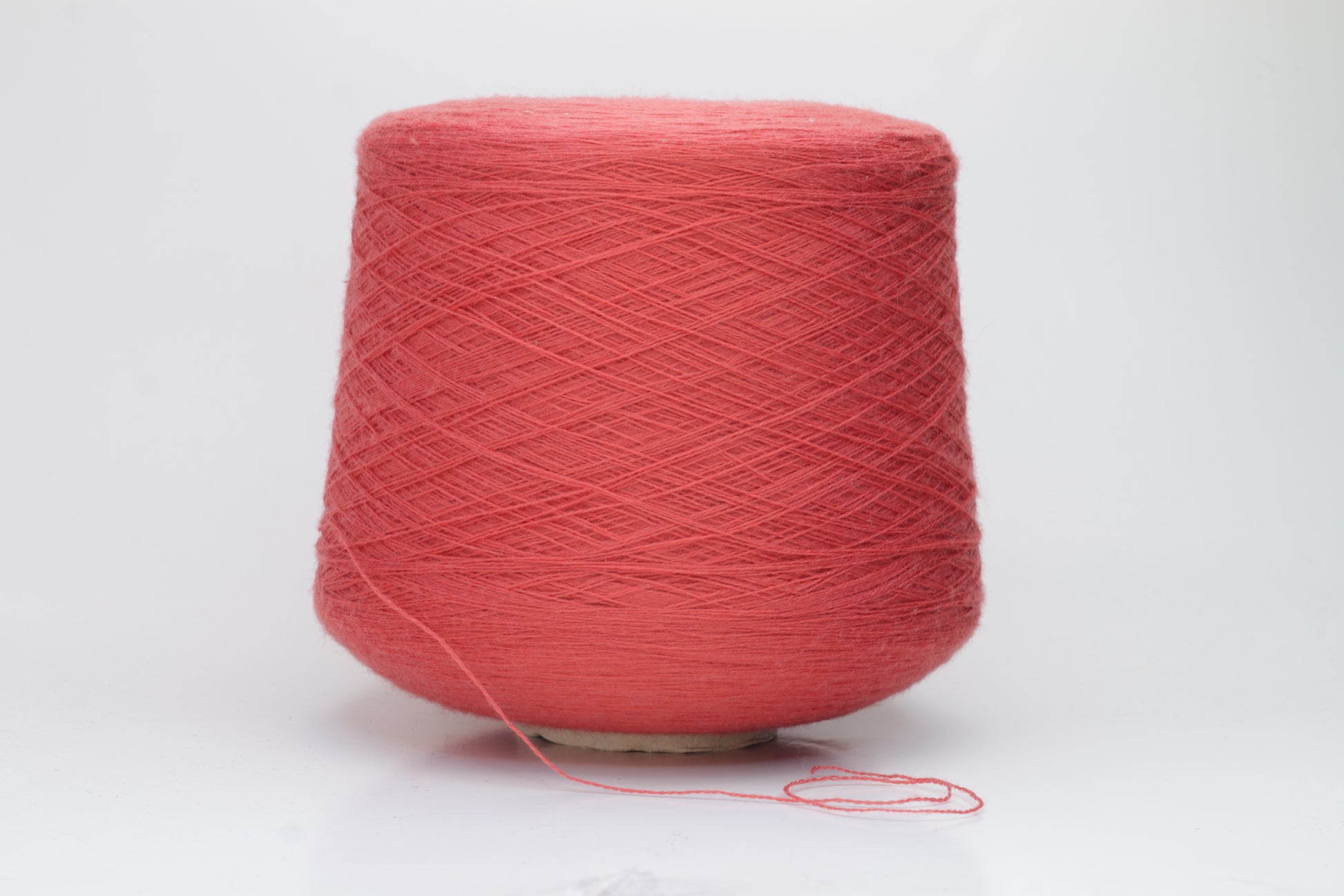 Close-up shot of vibrant red Zegna Baruffa Merino 100% Cashwool yarn, showcasing a tight 2/30 Nm ply twist and rich color depth, highlighting the wool's natural sheen and fluffy texture.