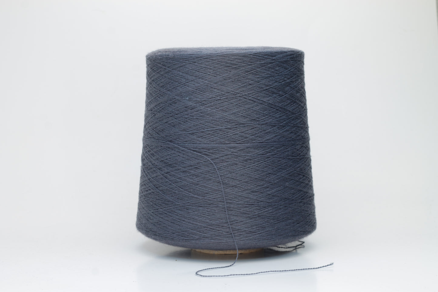 Close-up of luxurious Dark Gray Merino wool yarn, two-ply twist with a soft, subtle sheen, and fine, consistent thread structure.