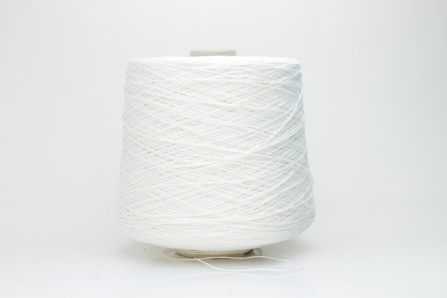 Close-up of pristine white linen and viscose blend yarn, softly twisted with a subtle sheen, showcasing its fine, smooth texture.