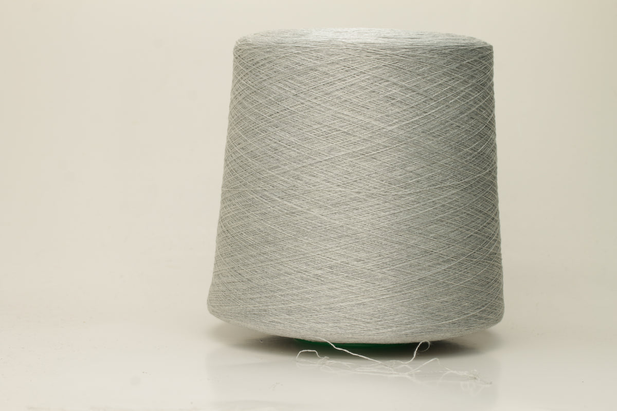 Close-up of a smooth, tightly plied gray yarn skein with a subtle, refined sheen, showcasing the luxurious blend of silk and cotton fibers.