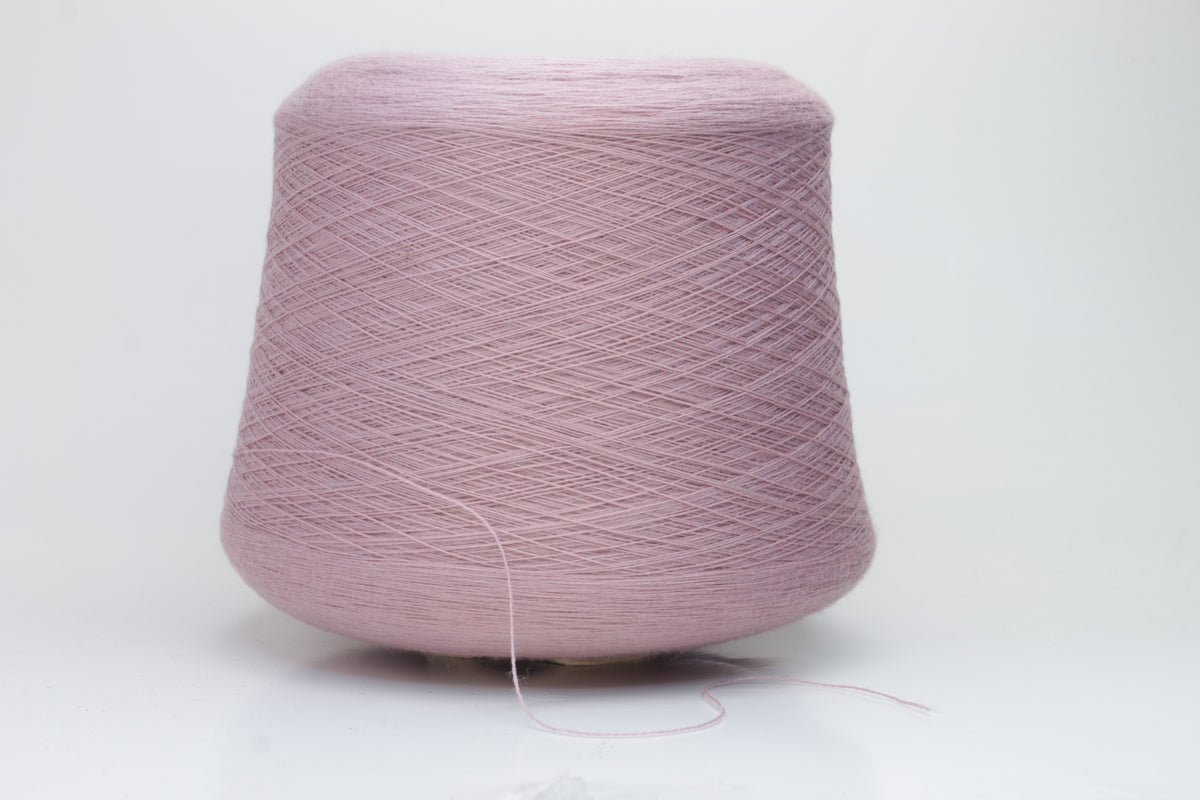 Close-up studio shot showcasing the 'Harmony 2' merino yarn in a rich 'Rosa' hue. The yarn exhibits a tight, twisted ply with an even thread structure, creating subtle sheen and a fluffy texture.