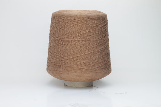 A finely spun, single-ply yarn in an earthy light brown hue, showcasing a delicate, rustic texture and a subtle, natural matte sheen.