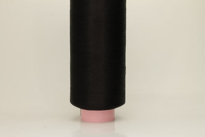 A skein of fine, single-ply 100% silk yarn, lustrous with a deep, rich Black hue, reflecting light softly.