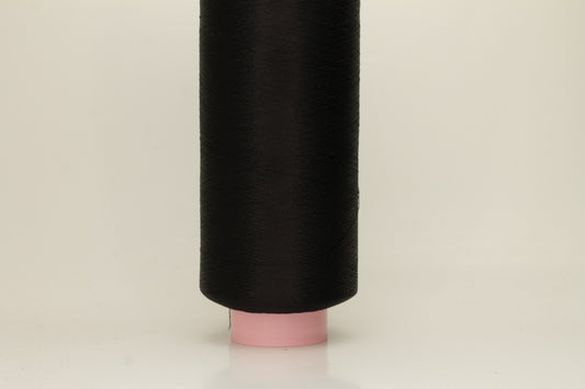 A skein of fine, single-ply 100% silk yarn, lustrous with a deep, rich Black hue, reflecting light softly.