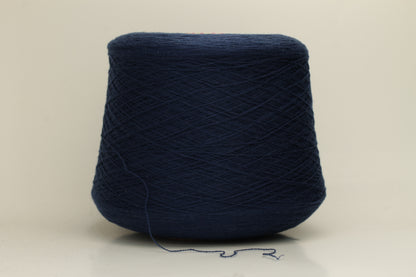Close-up of a luxurious, soft dark blue 2-ply cashmere yarn, subtly twisted with a delicate sheen and rich, deep color saturation.