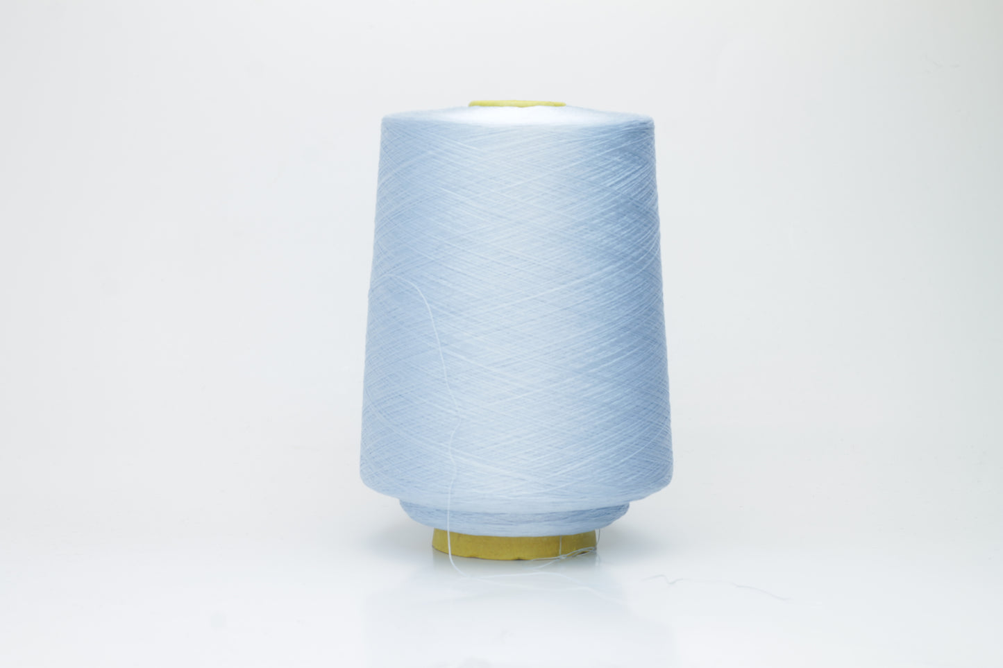 Close-up of radiant Azzurro blue silk yarn, featuring a finely spun, lustrous organzino thread with a pronounced, smooth sheen.