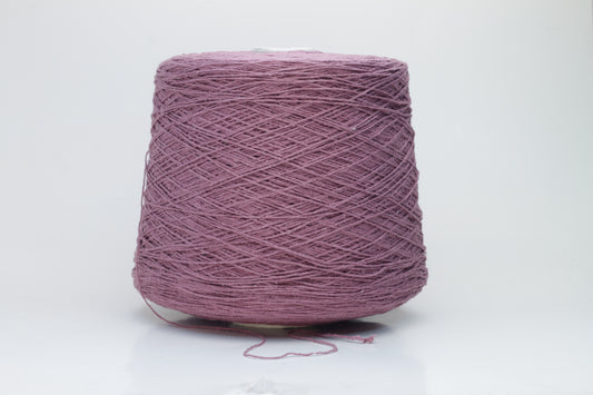 Close-up image of the burgundy silk bourette yarn, showcasing a dense ply twist and subtle sheen. The yarn appears incredibly soft and fluffy with rich color depth.