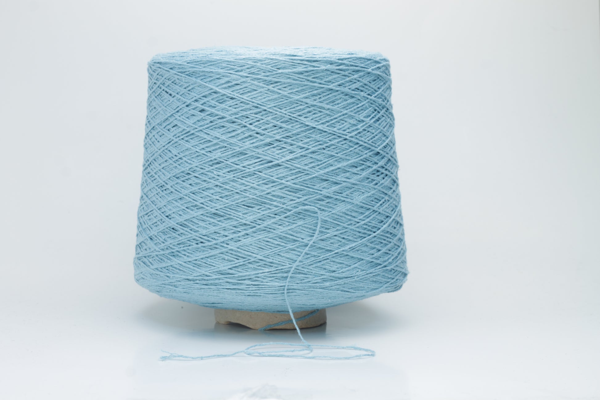 Close-up shot showcasing the shimmering, fluffy texture of the Coscata Silk Bourette yarn, with visible ply twists and a subtle sheen, highlighting its luxurious feel.