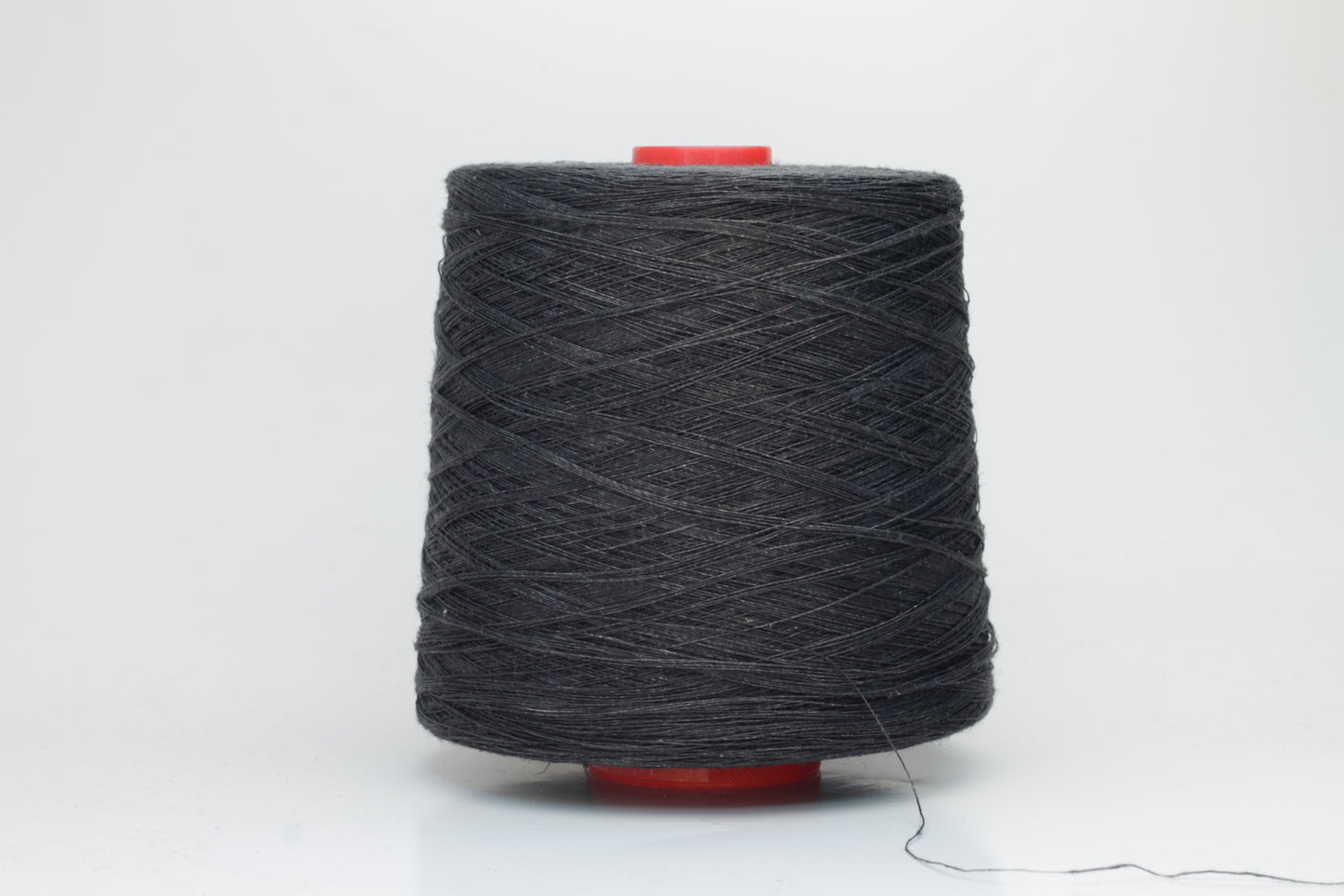 Fine, single-ply linen yarn in a rich Charcoal Black. Reveals a crisp texture and subtle natural sheen, typical of pure linen fiber.
