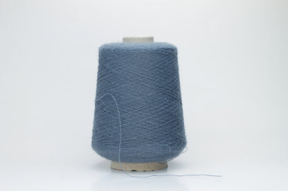 Close-up of a skein of soft, plied alpaca merino yarn in a deep Blue, showing subtle sheen and fine fiber halo.