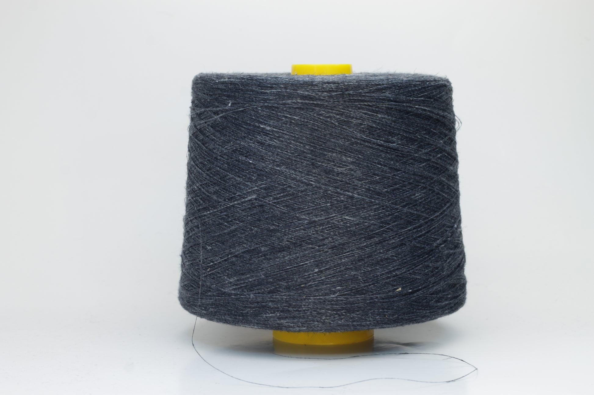 Fine, single-ply linen yarn in a rich Storm Gray. Reveals a crisp texture and subtle natural sheen, typical of pure linen fiber.