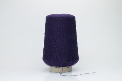 Rich purple 2-ply Alpaca Merino yarn, softly twisted with a gentle halo and subtle sheen, showcasing its deep, luxurious color saturation.
