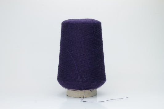 Rich purple 2-ply Alpaca Merino yarn, softly twisted with a gentle halo and subtle sheen, showcasing its deep, luxurious color saturation.