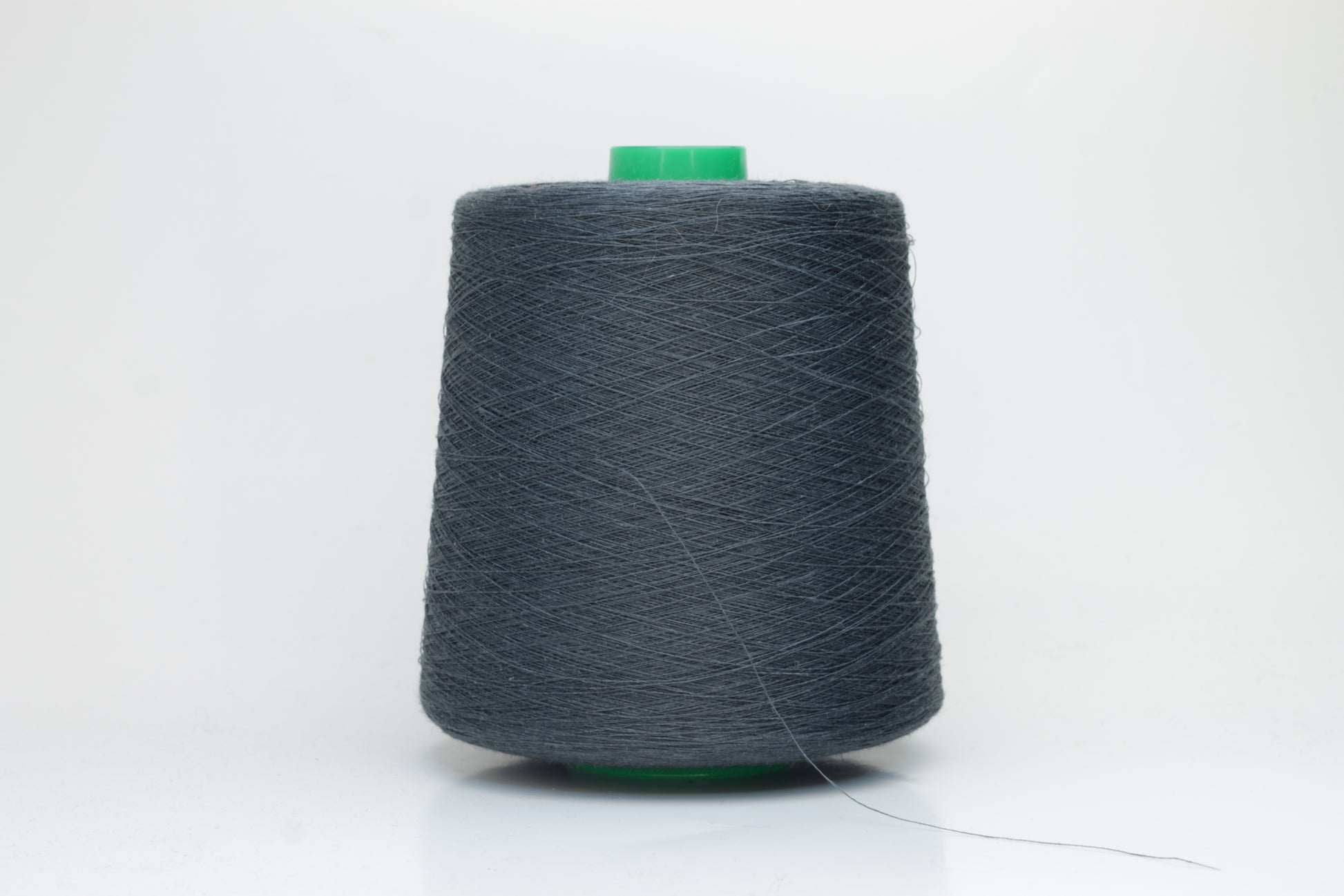 Fine, single-ply linen yarn in a rich Charcoal Grey. Reveals a crisp texture and subtle natural sheen, typical of pure linen fiber.