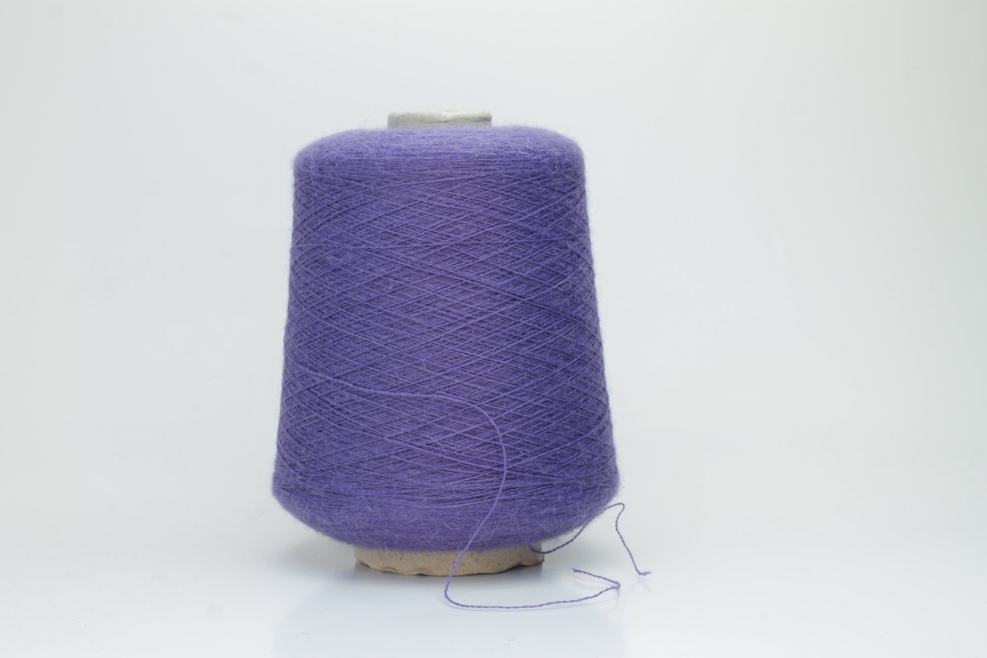 Rich purple 2-ply Alpaca Merino yarn, softly twisted with a gentle halo and subtle sheen, showcasing its deep, luxurious color saturation.